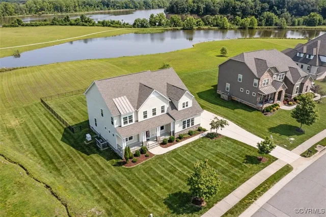an aerial view of a house with a ocean view