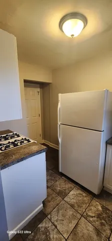 a kitchen with a refrigerator and a stove