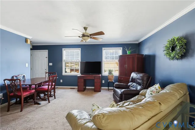a living room with furniture flowerpot and a window