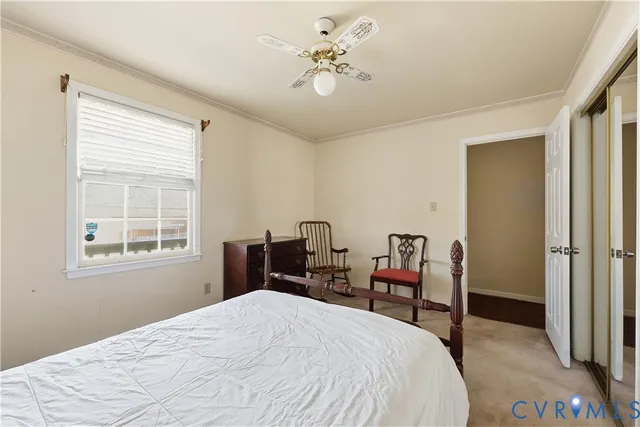a bedroom with a bed and a table in it with window