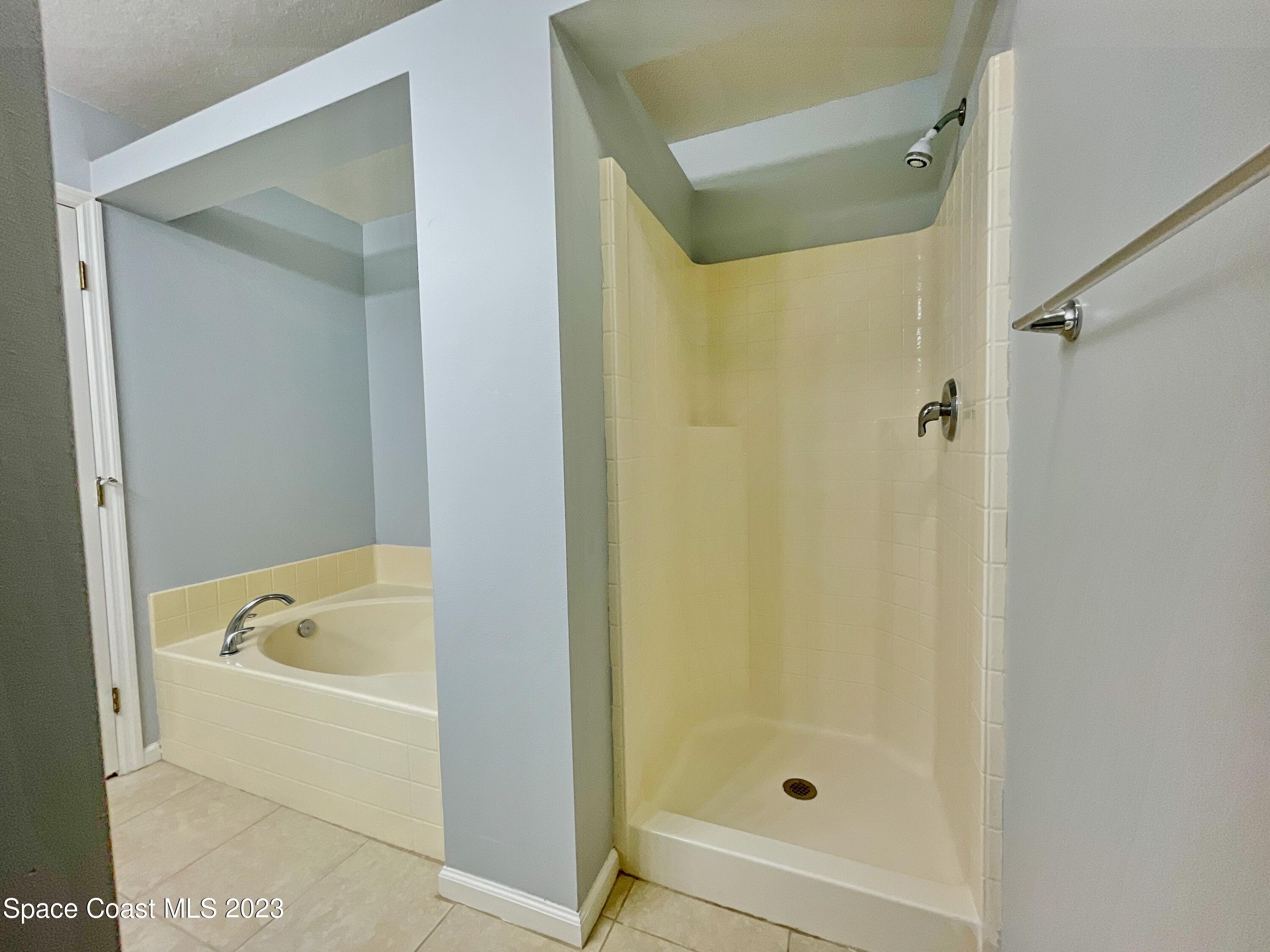 880 Kimberly Road Palm Bay, FL 32908 - Photo 9 of 18 a bathroom with a tub shower vanity and a sink