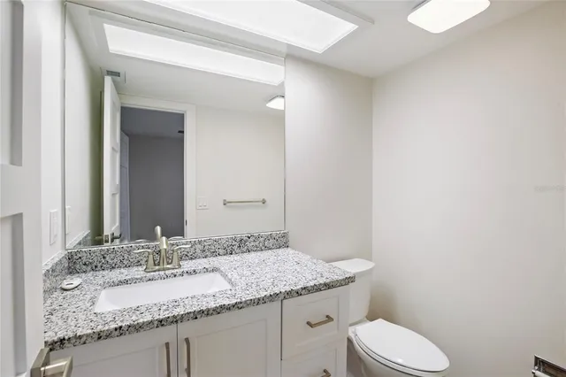 a view of empty room with wooden floor and window