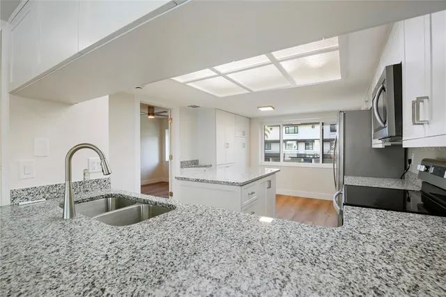 a view of empty room with wooden floor and window