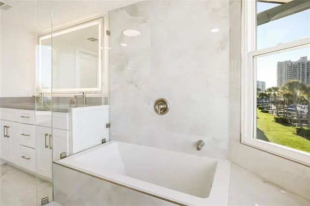 a large bathroom with a large tub and sink