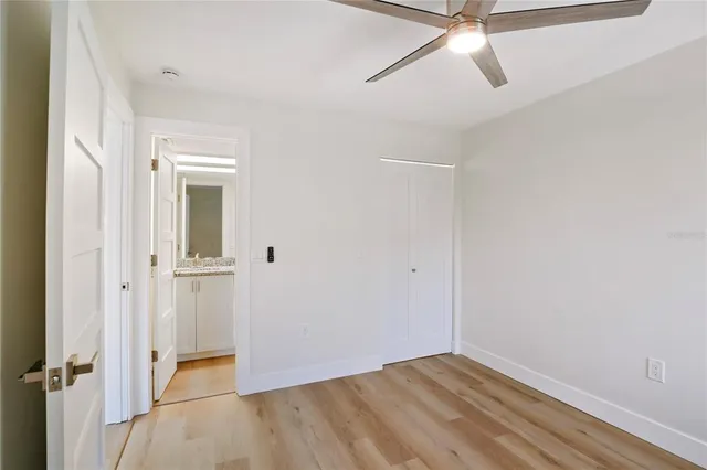 a bathroom with a granite countertop toilet sink and mirror