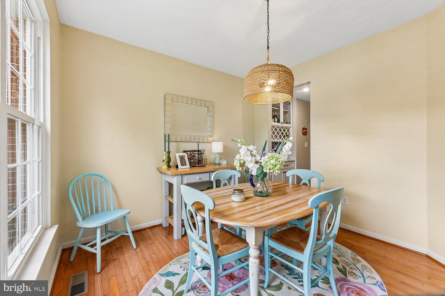 3707 Turn Back Trail Triangle, VA 22172 - Photo 7 of 55 a dining room with furniture wooden floor a rug and a chandelier