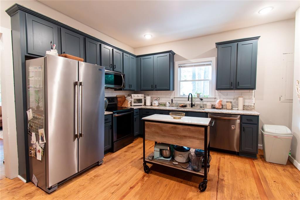 702 Radford Street Monroe, GA 30655 - Photo 9 of 49 a kitchen with a refrigerator stove and sink