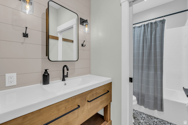 1766 West Tollgate Cyn Road Coalville, UT 84017 - Photo 36 of 59 Bathroom featuring a rectangular sink set in a wood-finish vanity, matte black faucet, and a rectangular framed mirror