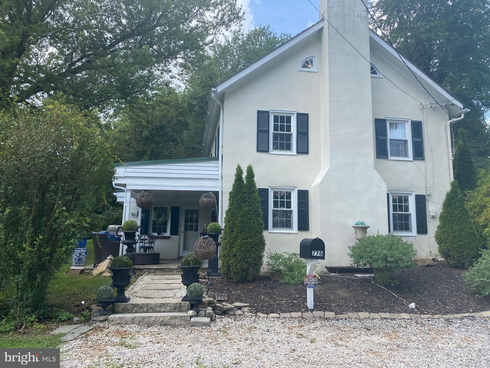 a view of a chair and table in backyard of the house