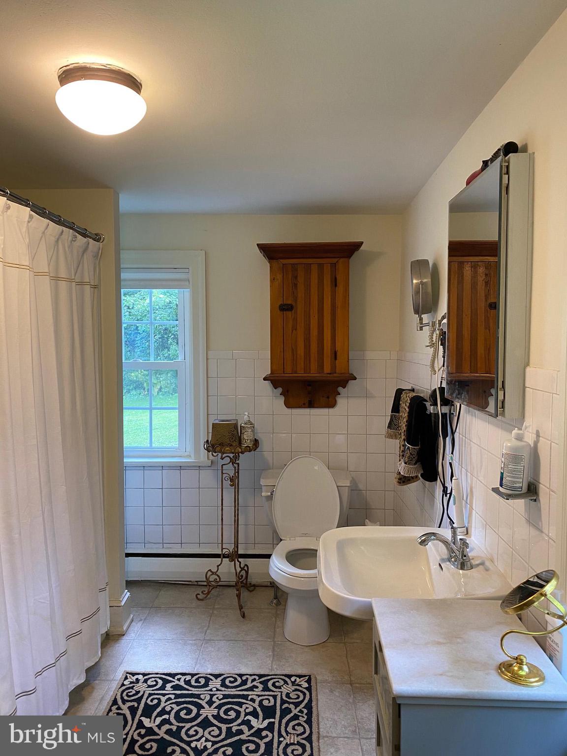 776 W Road West Grove, PA 19390 - Photo 19 of 26 a bathroom with a sink a toilet and mirror