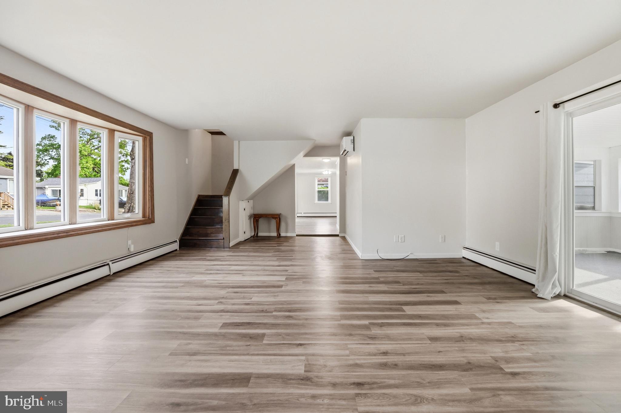 1816 Keymar Road Edgewater, MD 21037 - Photo 14 of 42 a view of an empty room with wooden floor and a window