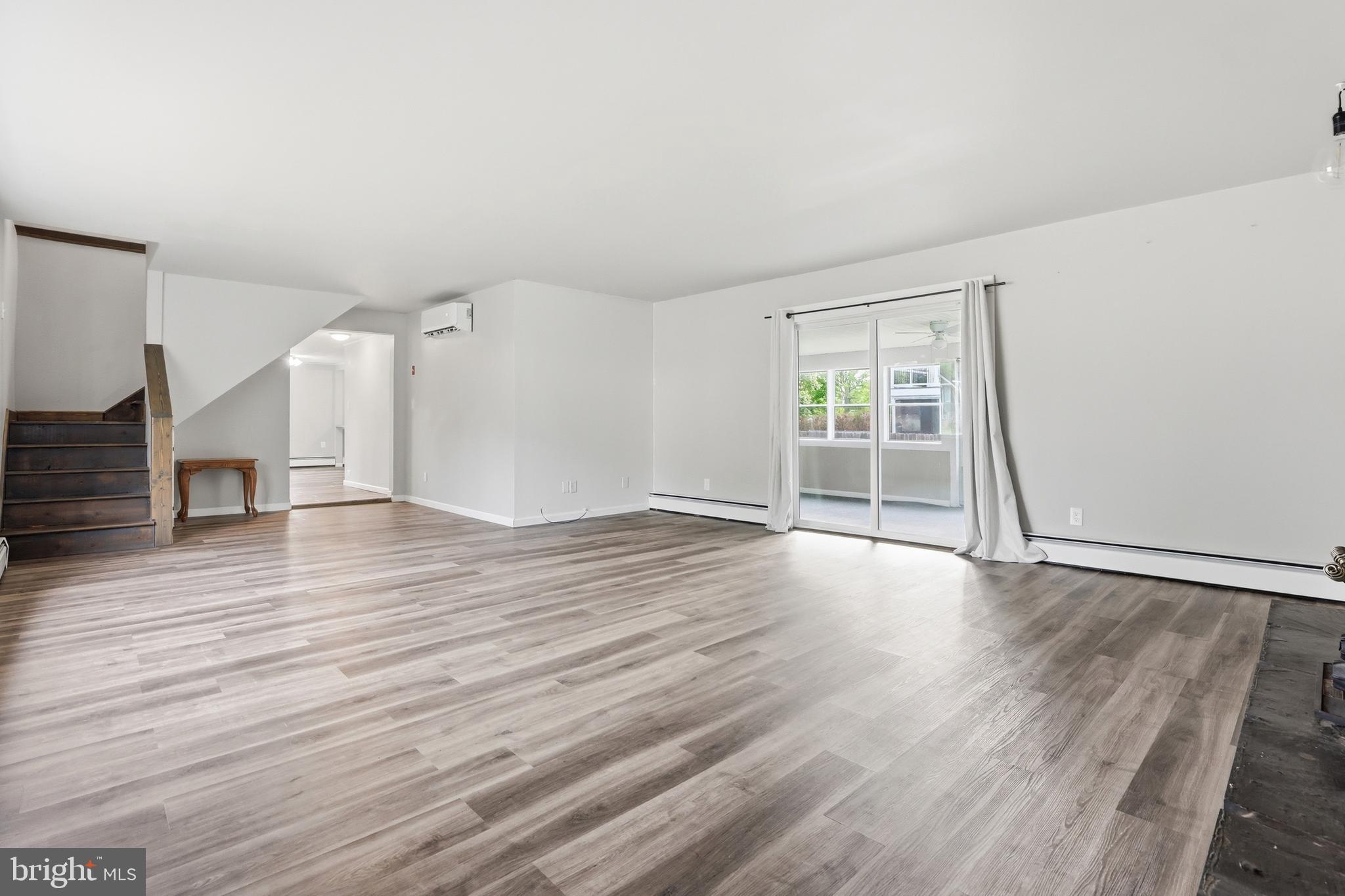 1816 Keymar Road Edgewater, MD 21037 - Photo 15 of 42 an empty room with wooden floor and windows