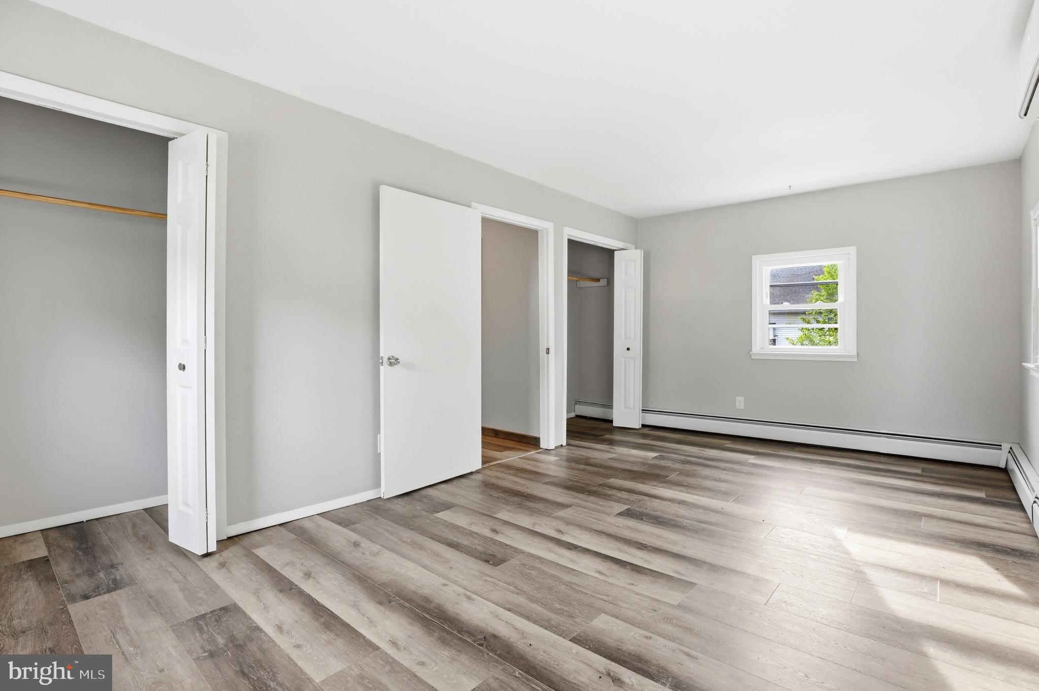 1816 Keymar Road Edgewater, MD 21037 - Photo 22 of 42 a view of an empty room with window and wooden floor
