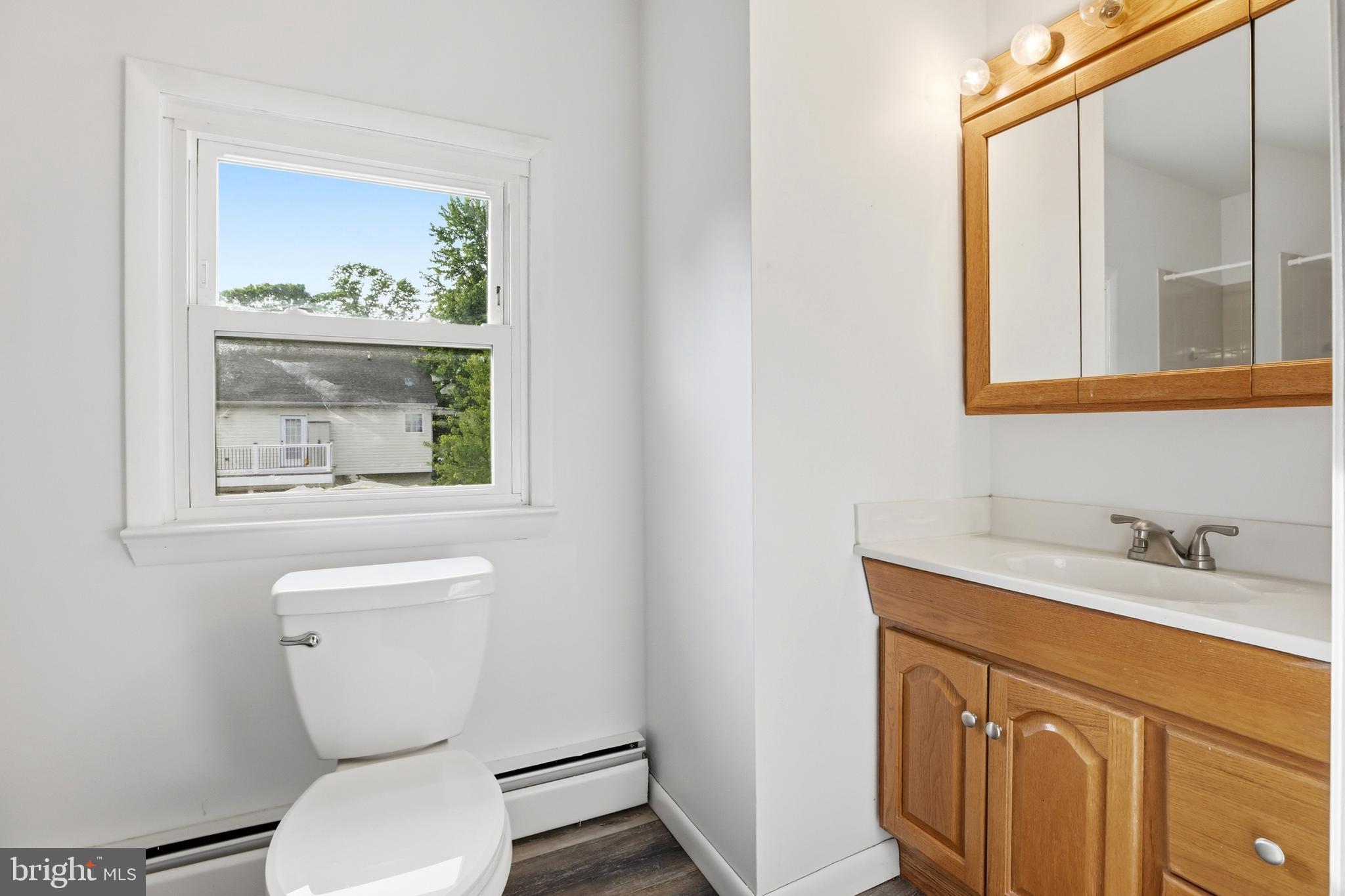 1816 Keymar Road Edgewater, MD 21037 - Photo 27 of 42 a bathroom with a toilet a sink and a window