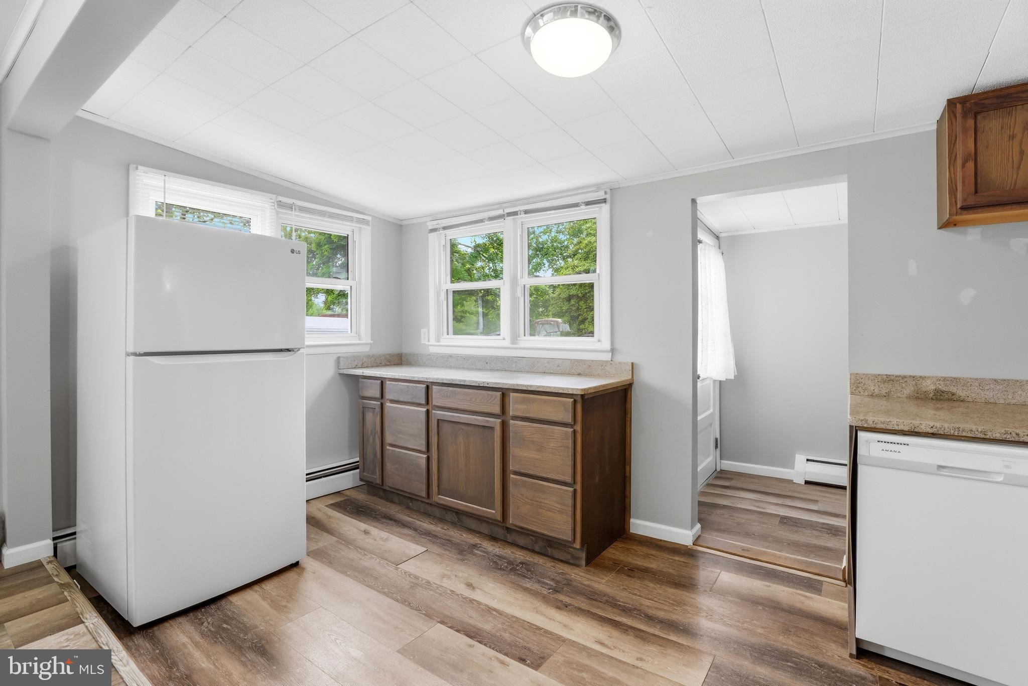 1816 Keymar Road Edgewater, MD 21037 - Photo 41 of 42 a kitchen with a refrigerator a stove a washer and dryer with wooden floor