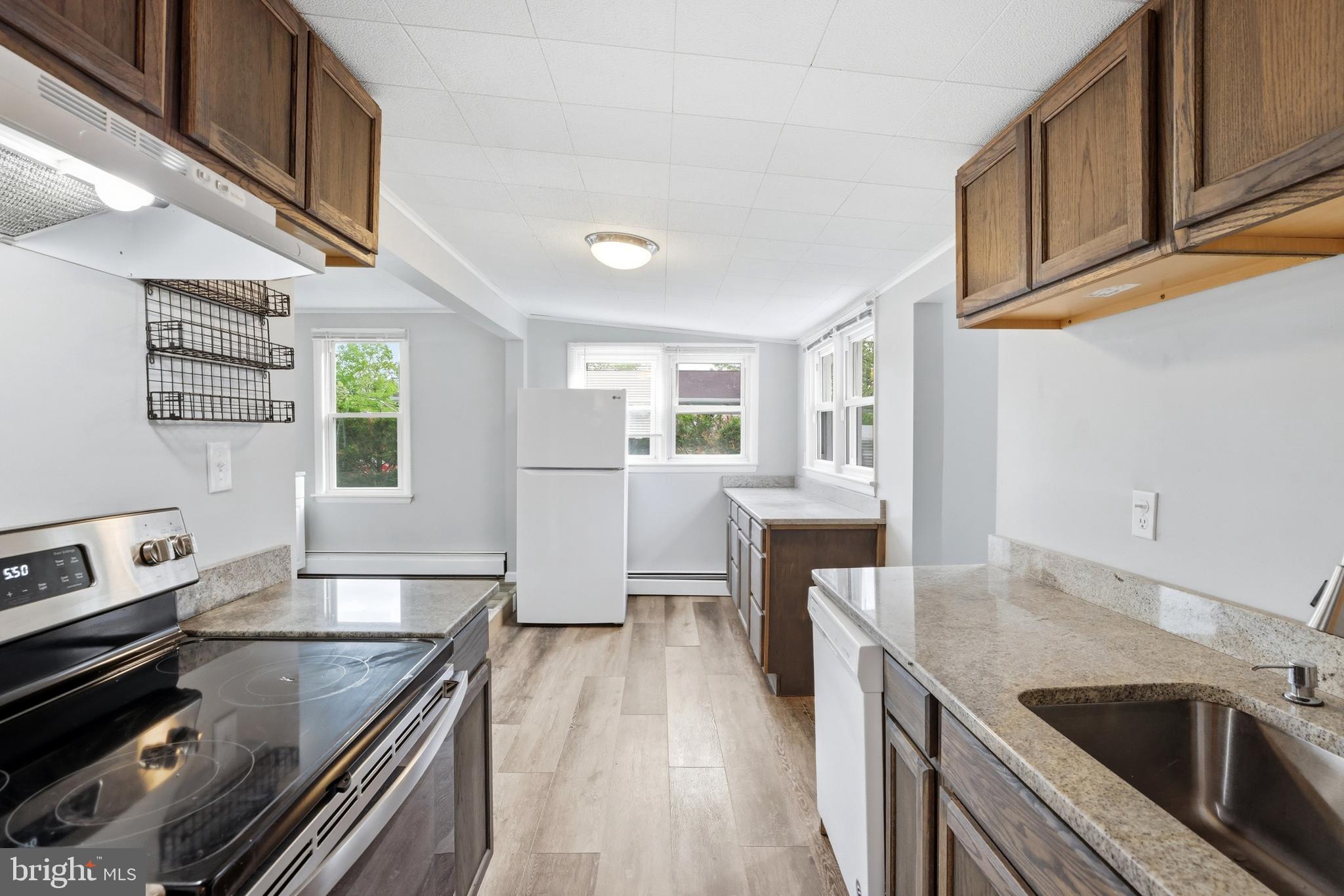 1816 Keymar Road Edgewater, MD 21037 - Photo 5 of 42 a kitchen with granite countertop a stove and a sink