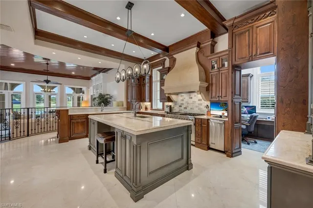 a kitchen with stainless steel appliances granite countertop a sink a stove and a refrigerator