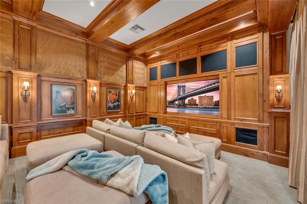 2125 Canna Way Naples, FL 34105 - Photo 18 of 43 Cinema with wood walls, a decorative wall, beam ceiling, and ornamental molding