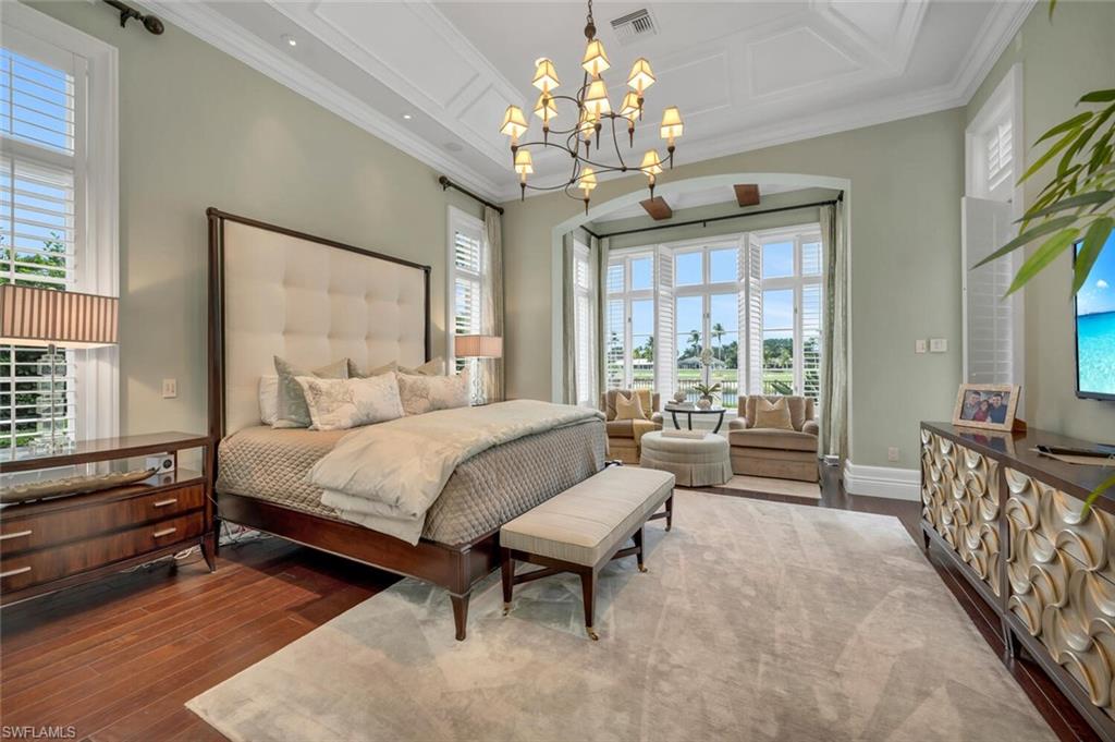2125 Canna Way Naples, FL 34105 - Photo 19 of 43 Bedroom with coffered ceiling, multiple windows, dark wood-style floors, and ornamental molding