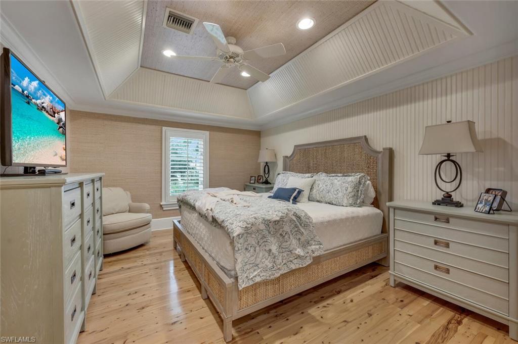 2125 Canna Way Naples, FL 34105 - Photo 29 of 43 Bedroom featuring a raised ceiling, ceiling fan, light wood finished floors, ornamental molding, and recessed lighting