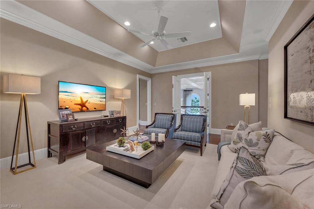 2125 Canna Way Naples, FL 34105 - Photo 32 of 43 Living area featuring crown molding, a tray ceiling, ceiling fan, and recessed lighting