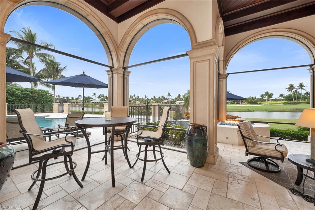 2125 Canna Way Naples, FL 34105 - Photo 37 of 43 View of patio / terrace with a water view and outdoor dining area