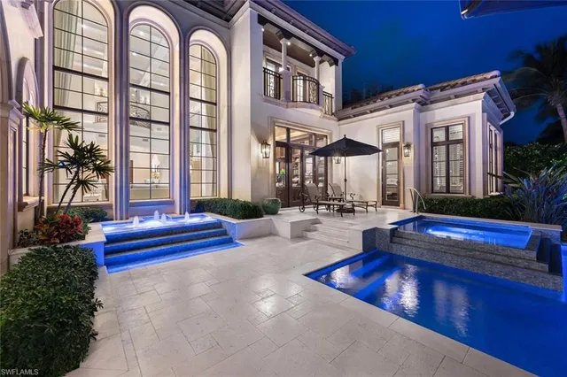 a swimming pool with outdoor seating and yard