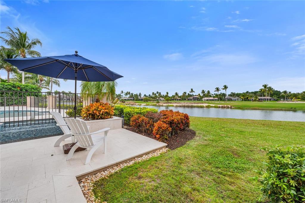 2125 Canna Way Naples, FL 34105 - Photo 41 of 43 View of yard with a water view, a patio, and a pool with connected hot tub