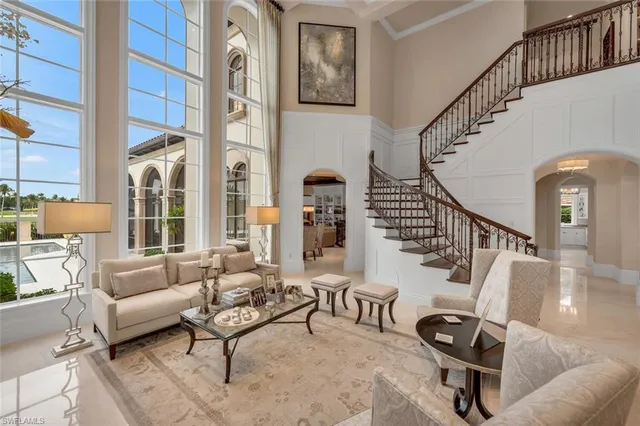 a living room with furniture fireplace and a large window