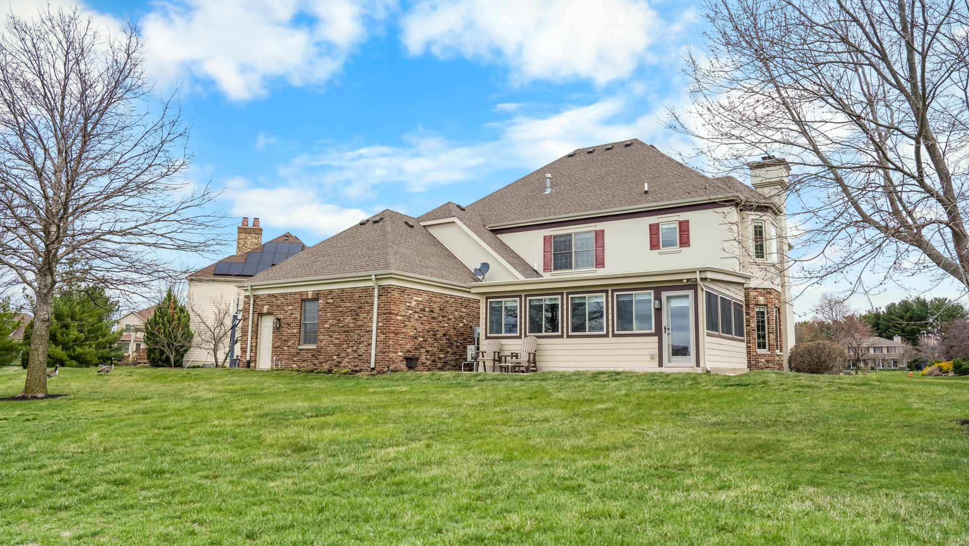 1607 Chestnut Grove Court Champaign, IL 61822 - Photo 110 of 113 a front view of a house with a garden and trees