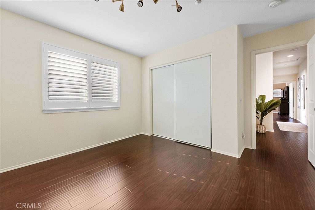 1749 Catania Drive Riverside, CA 92507 - Photo 17 of 39 a view of an empty room with wooden floor and a window