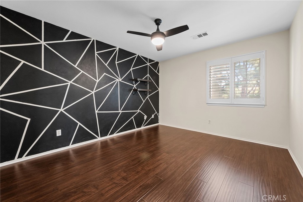 1749 Catania Drive Riverside, CA 92507 - Photo 18 of 39 an empty room with wooden floor and windows
