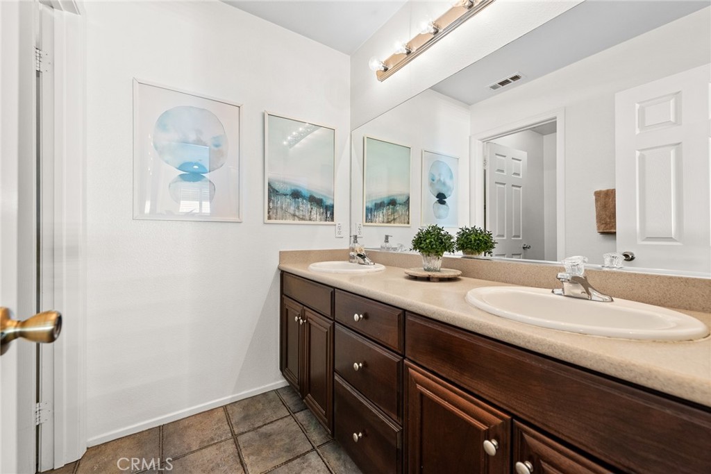 1749 Catania Drive Riverside, CA 92507 - Photo 20 of 39 a bathroom with a double vanity sink and a window