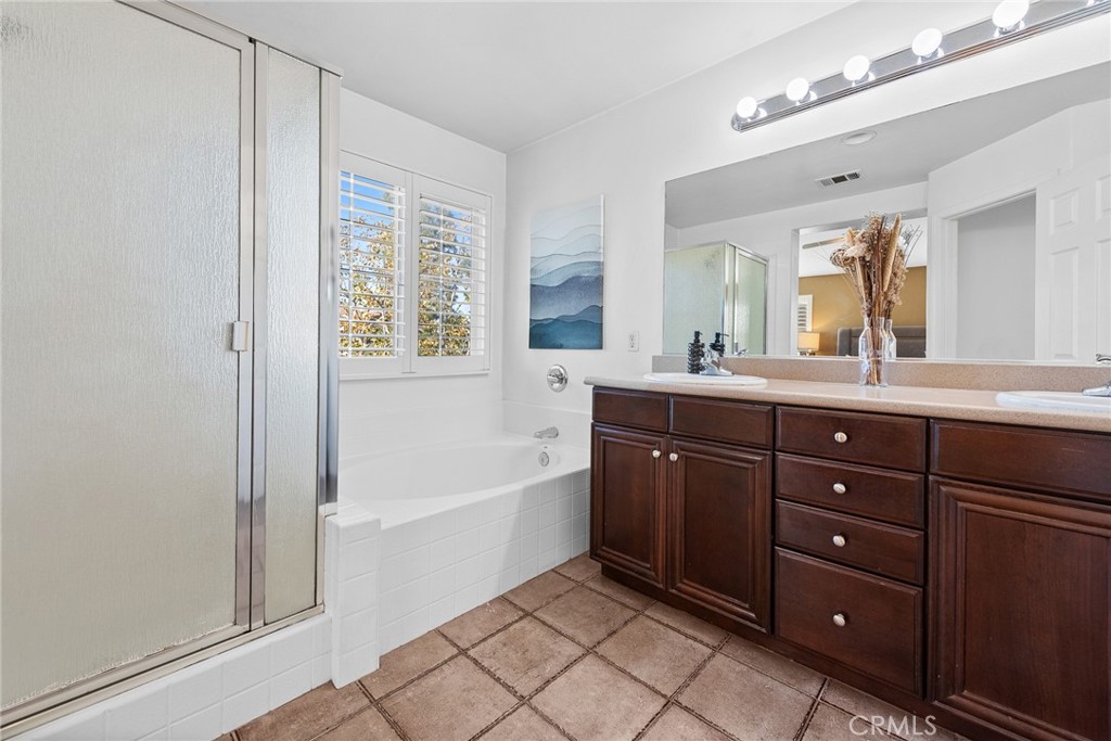 1749 Catania Drive Riverside, CA 92507 - Photo 29 of 39 a spacious bathroom with a tub sink shower and mirror