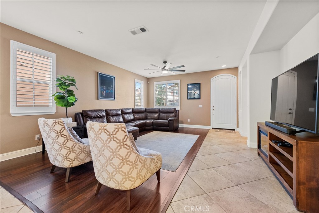 1749 Catania Drive Riverside, CA 92507 - Photo 6 of 39 a living room with furniture a large window and a flat screen tv
