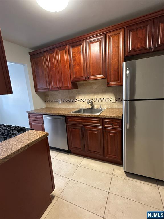 166 Grand Avenue, Unit A7 Englewood, NJ 07631 - Photo 5 of 12 a kitchen with a stove a refrigerator and a sink