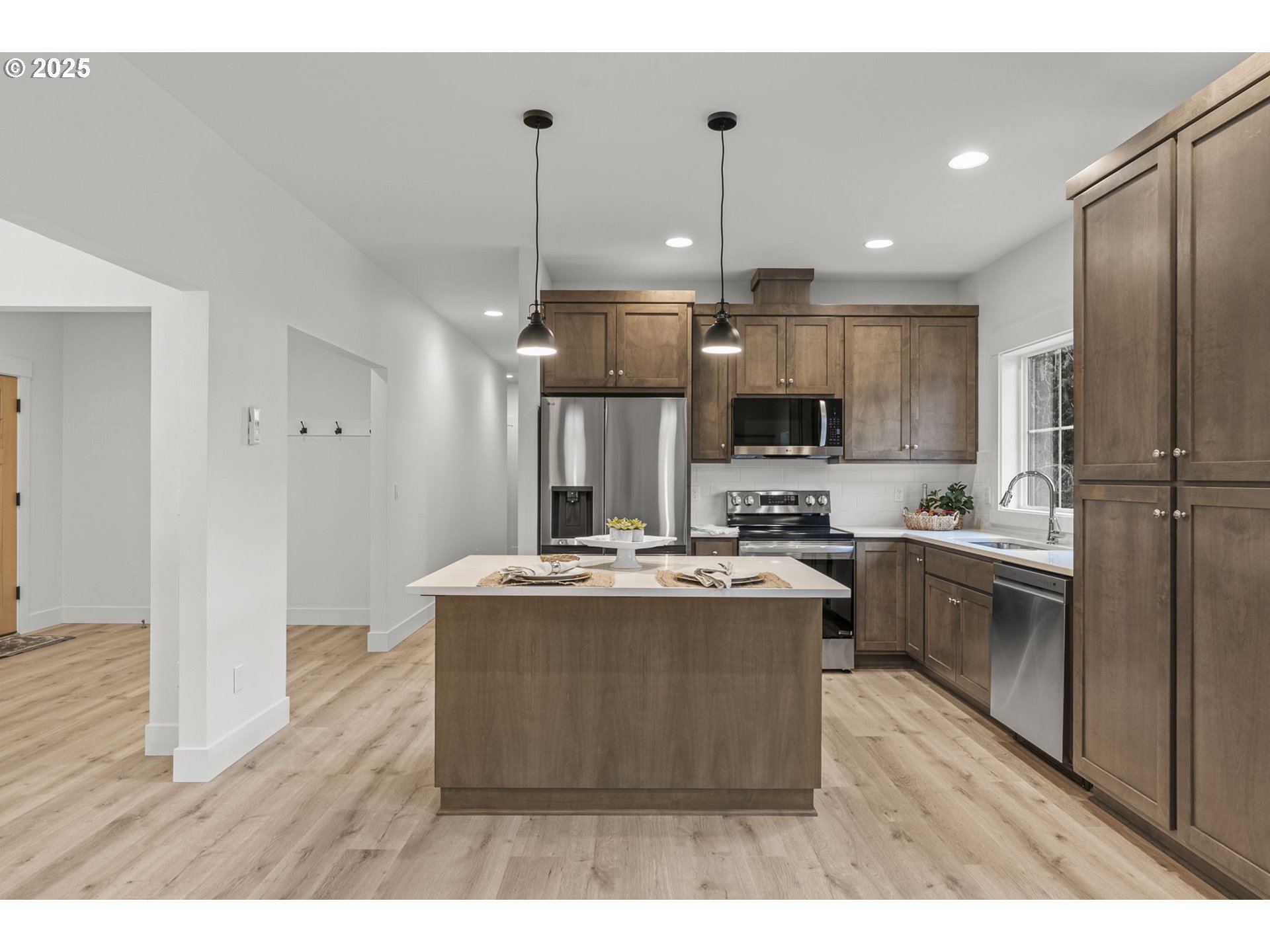 960 Paine Road Castle Rock, WA 98611 - Photo 16 of 32 a view of kitchen with kitchen island stainless steel appliances a stove a sink and a refrigerator