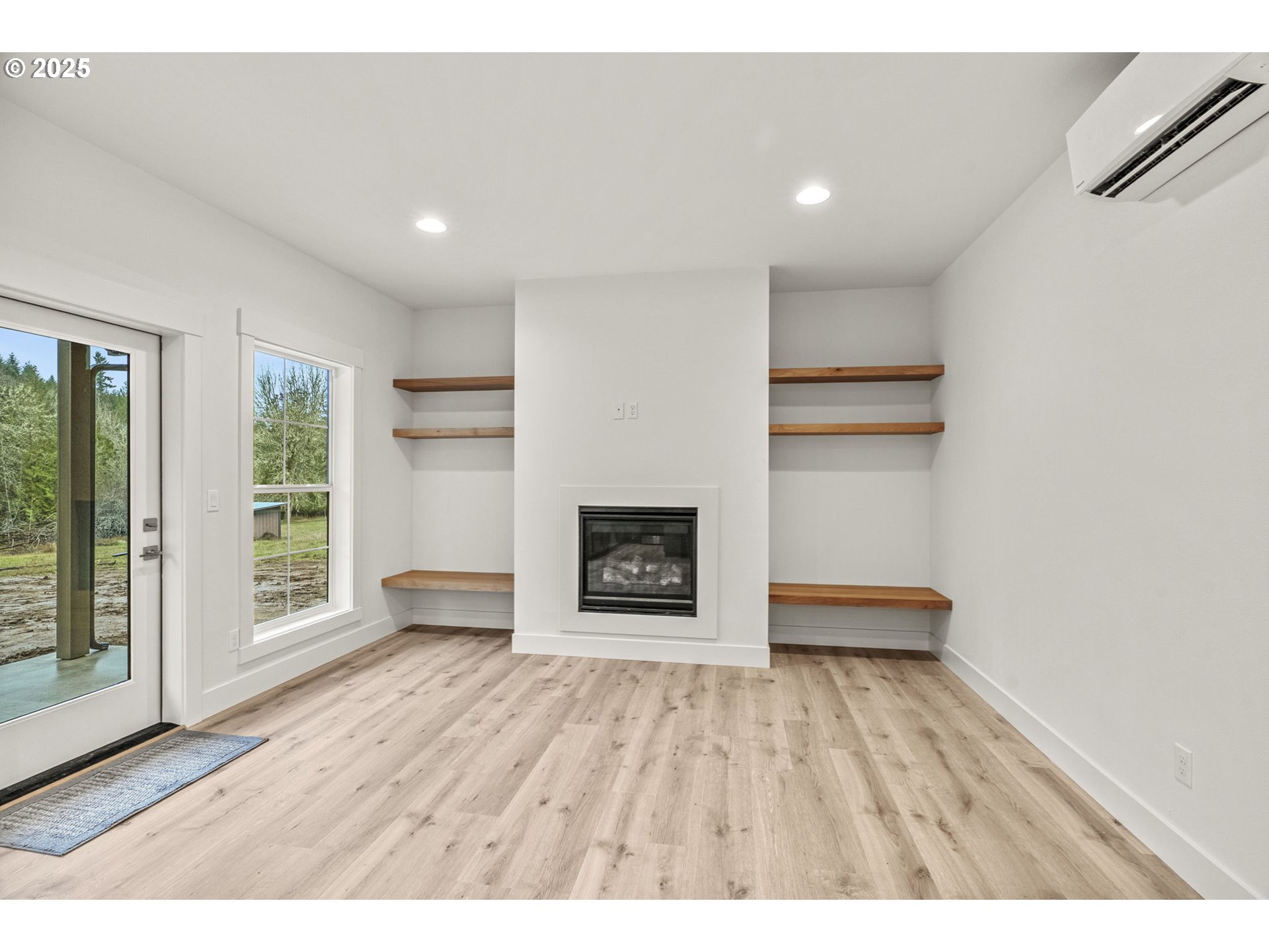 960 Paine Road Castle Rock, WA 98611 - Photo 20 of 32 a view of an empty room with a window and wooden floor