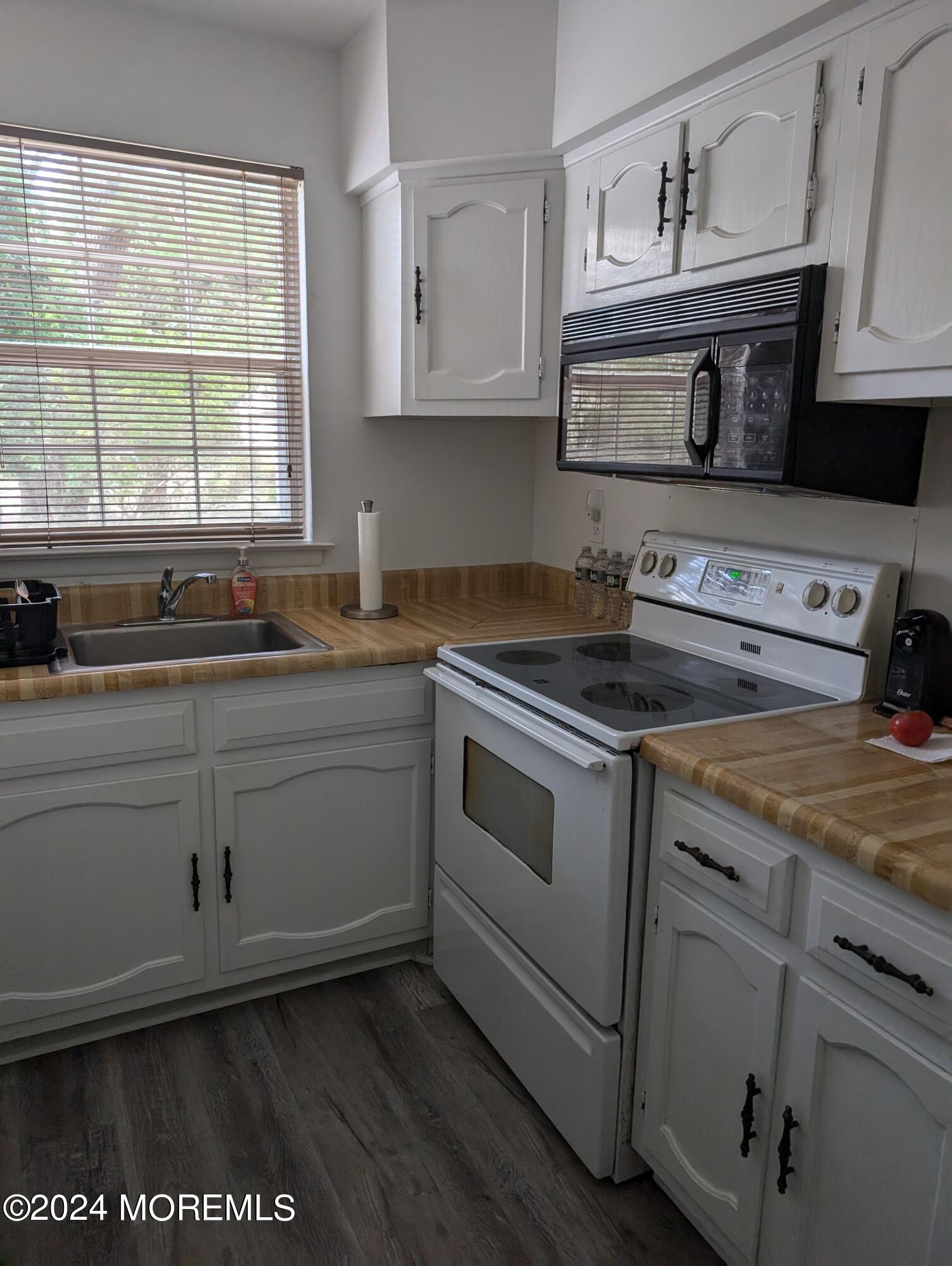4 D Bristol Street, Unit 51 Whiting, NJ 08759 - Photo 4 of 8 a kitchen with stainless steel appliances granite countertop a sink stove and cabinets