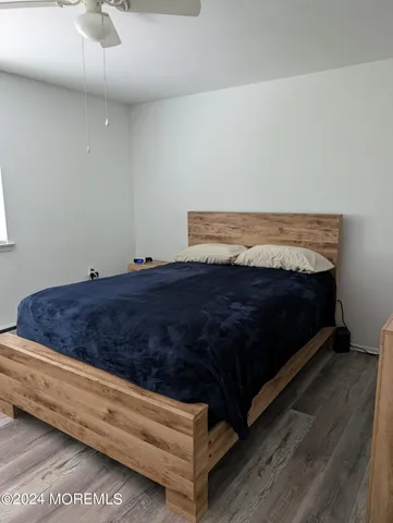 a bed sitting in a room next to a rug