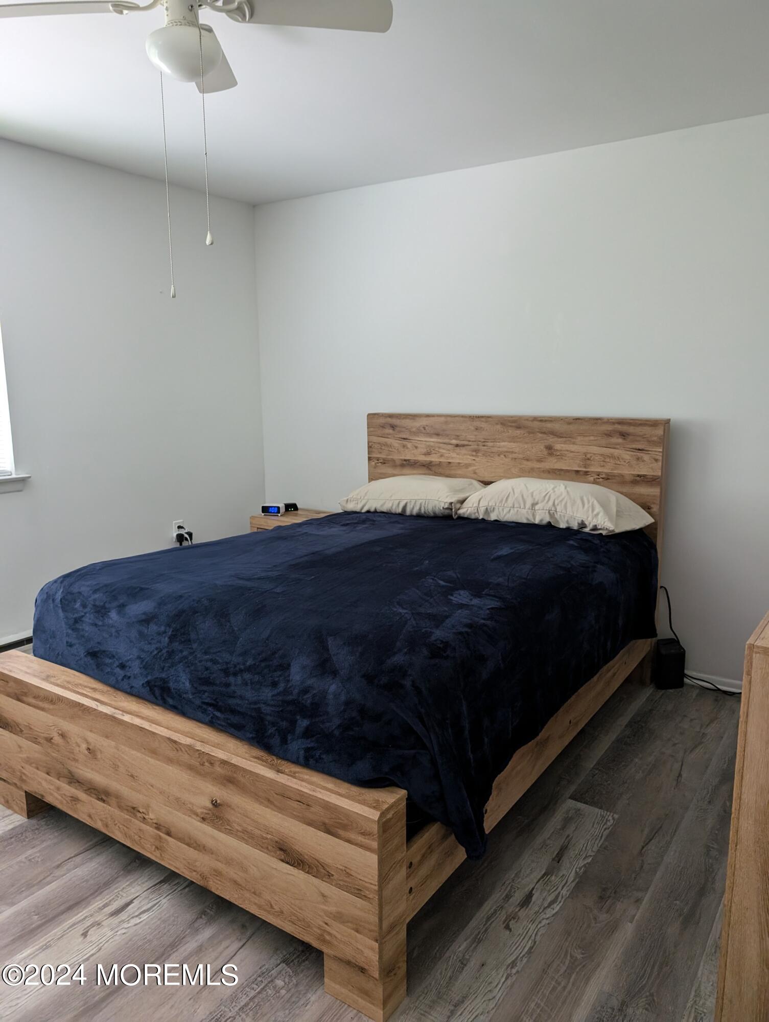 4 D Bristol Street, Unit 51 Whiting, NJ 08759 - Photo 7 of 8 a bed sitting in a room next to a rug