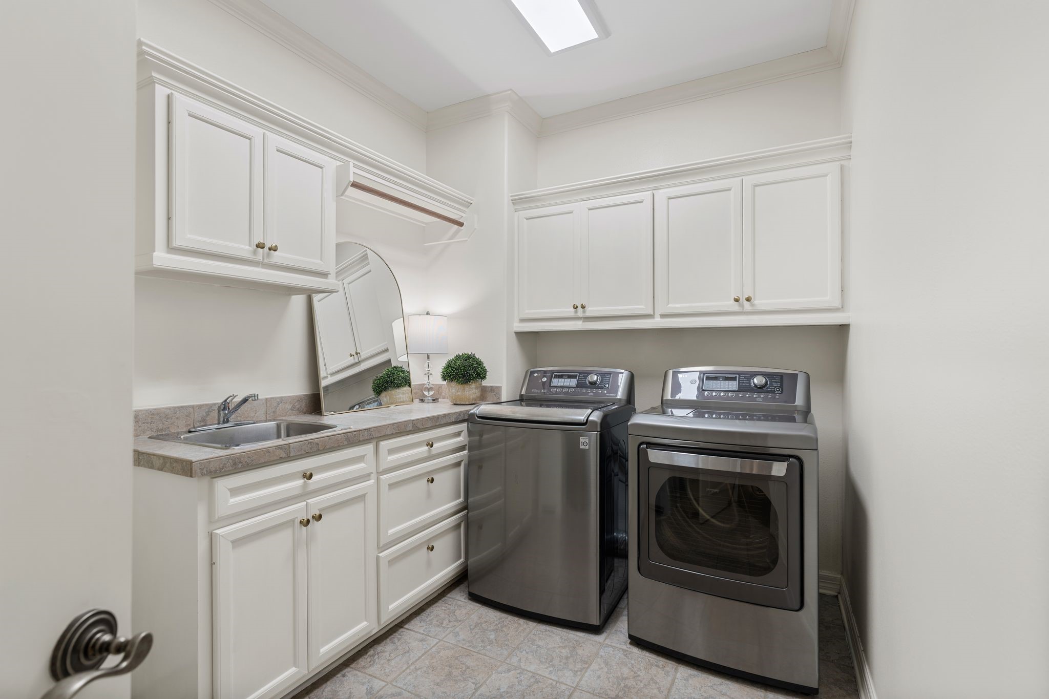 30 Hackberry Lane, Unit A Houston, TX 77027 - Photo 30 of 42 Utility room with a utility since, cabinetry and handing rack.
