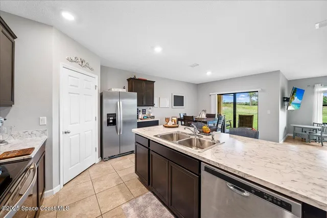 a kitchen with a sink stove and refrigerator