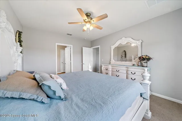 a bedroom with a bed and ceiling fan