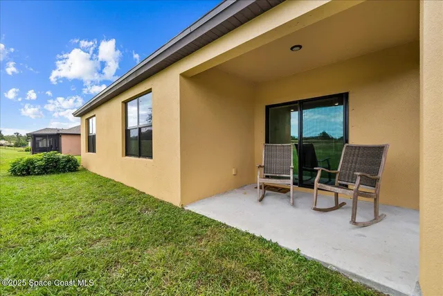 a view of a backyard with chair and table