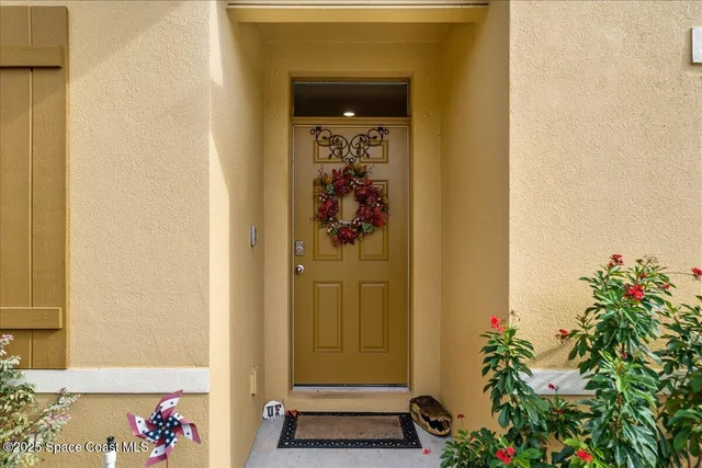 a front view of a house with a potted plant