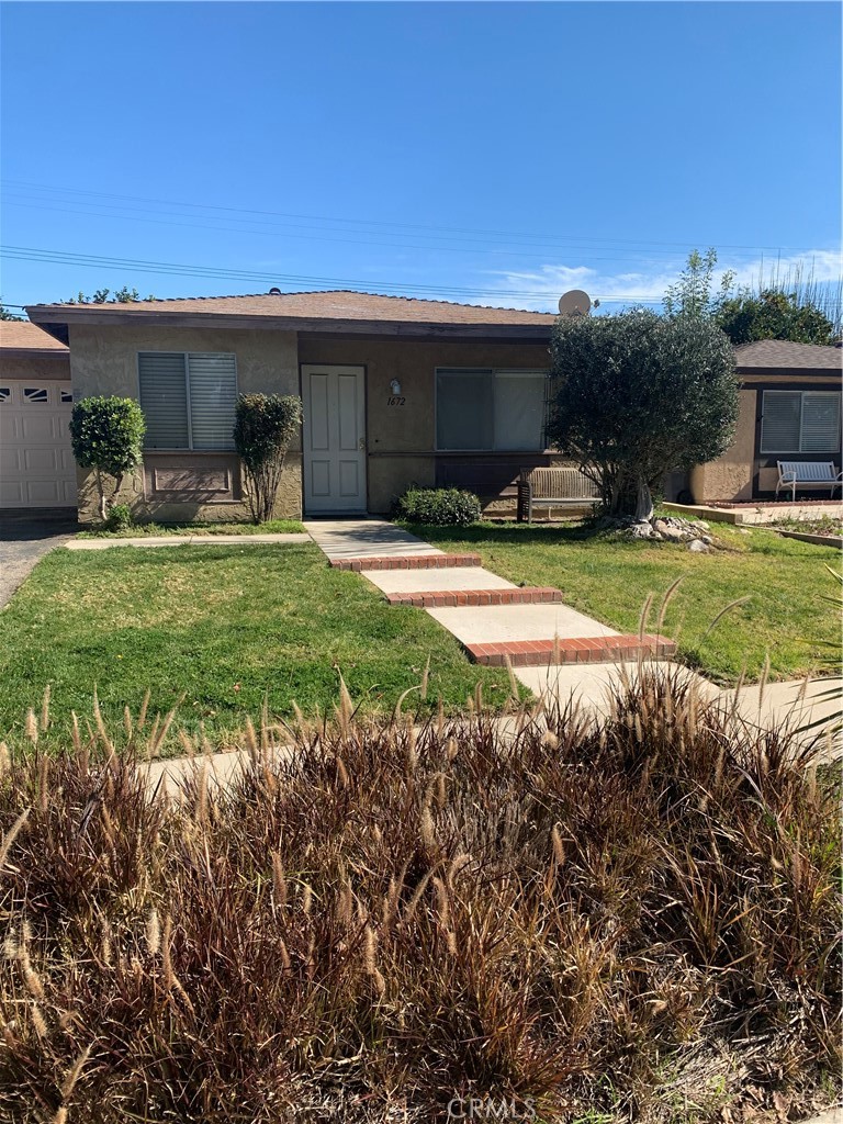 a front view of a house with garden
