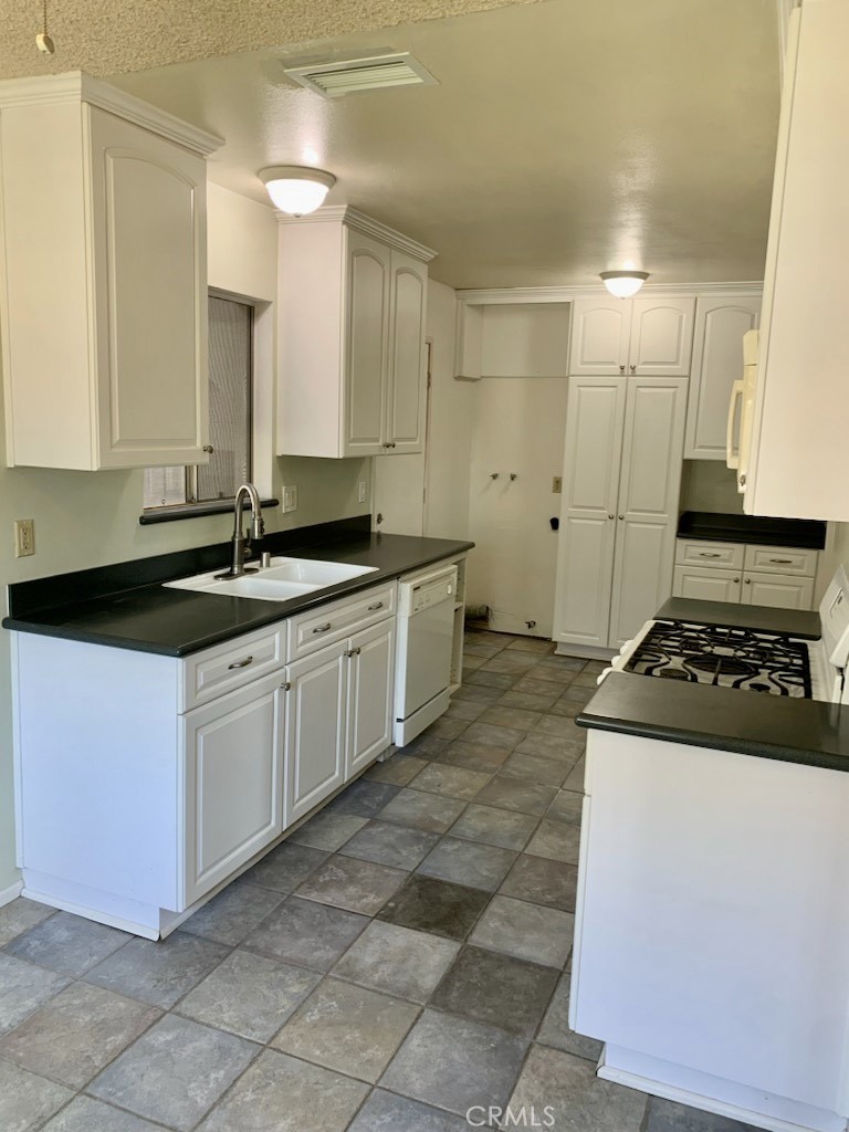 1672 Moreno Drive Simi Valley, CA 93063 - Photo 4 of 10 a kitchen with a sink stove and cabinets
