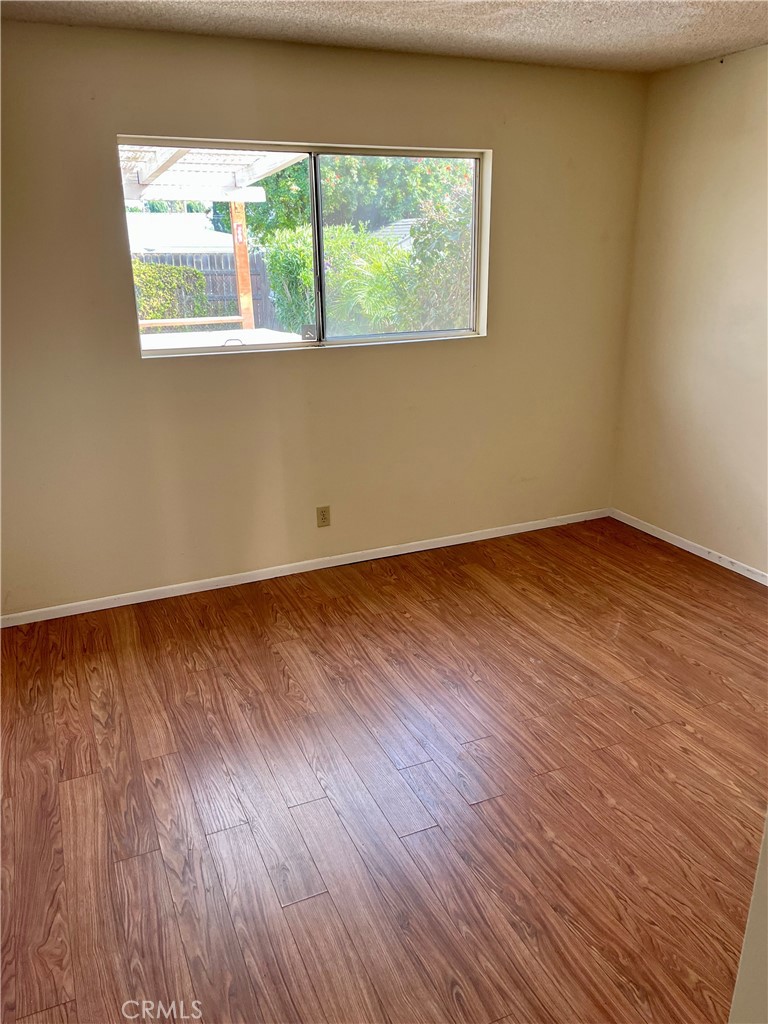 1672 Moreno Drive Simi Valley, CA 93063 - Photo 9 of 10 a view of an empty room with wooden floor and a window