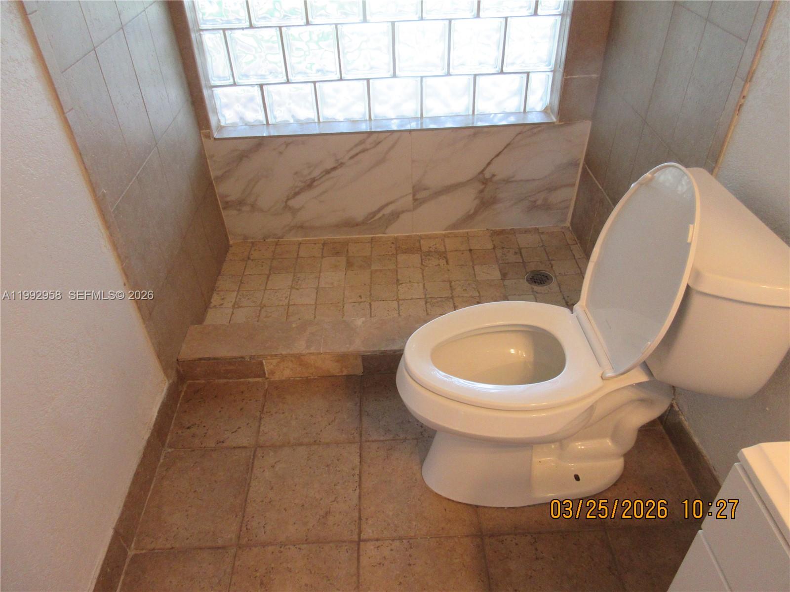 18420 Southwest 129th Avenue Miami, FL 33177 - Photo 11 of 17 a white toilet sitting next to a white sink